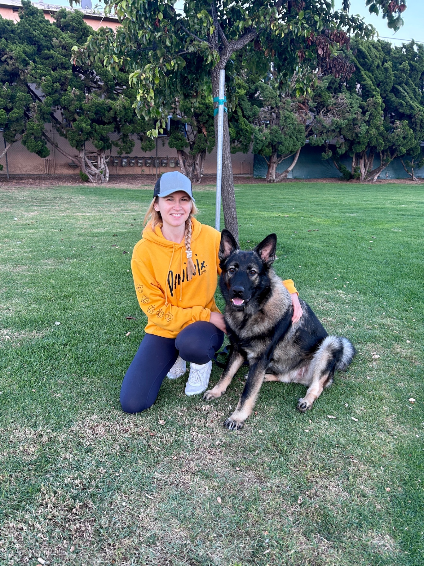 Anastasiia with a working-line German Shepherd on a South Bay field